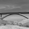 A curving bridge over a dry river in Lorena Station