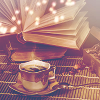 readera: a cup of tea with an open book behind it (books with tea)
