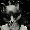 wearing_tearing: black and white icon of a person holding a wolf mask to their face. (Default)
