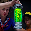 wolfish_willow: Steve Harrington and Dustin Henderson from Stranger Things holding a glowing green cylinder (Default)