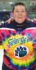 rmc28: Rachel in a bright tie-dyed hockey jersey with the team name "Solar Bears" above a stylised bear pawprint (Default)