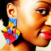 timeasmymeasure: side-profile of black woman wearing a brightly colored earring looking at the camera out of the side of her eye (stock: girl with a bright earring)