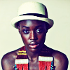 timeasmymeasure: black woman looking at the camera; she's wearing a white hat and an beaded necklace (stock: swag chill)