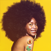 timeasmymeasure: erykah badu, shoulders bare, against a yellow background smiling at the camera (erykah: smile yellow)